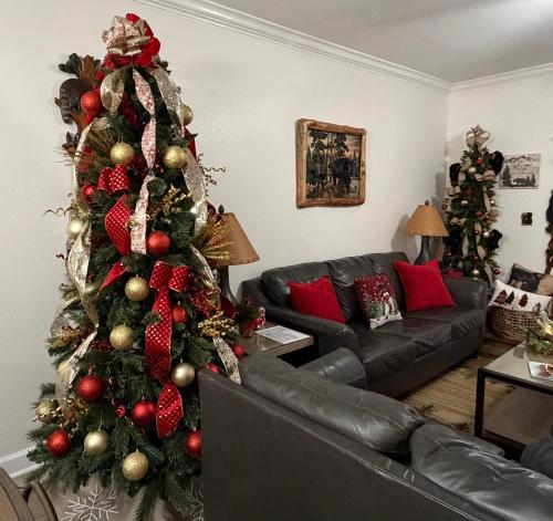 a christmas tree in a living room with a couch at A Beary Good Getaway condo in Pigeon Forge