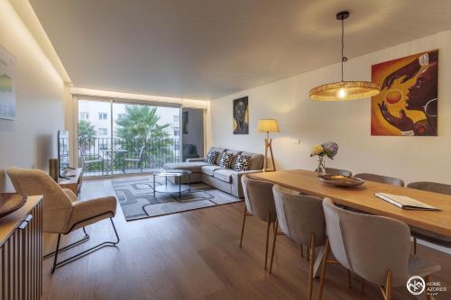 a living room with a table and a couch at Home Azores - Coliseu Residences in Ponta Delgada