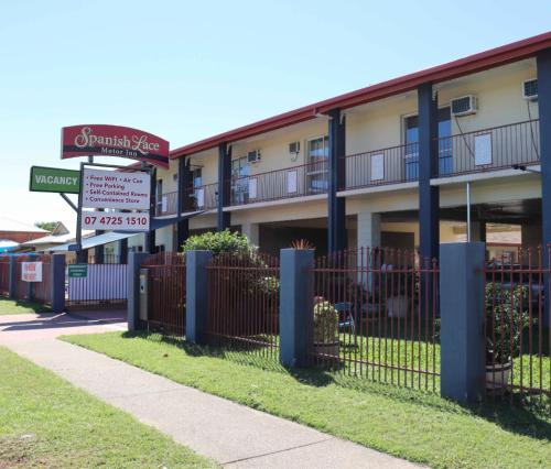 a building with a street sign in front of it at Spanish Lace Motor Inn in Townsville
