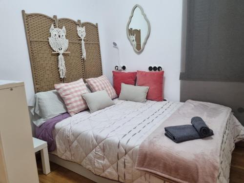 a bedroom with a large bed with pillows on it at Les Dos Nines in Monserrat