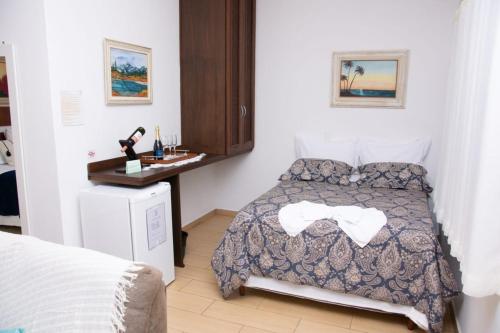 Ένα ή περισσότερα κρεβάτια σε δωμάτιο στο Pousada Medeiros