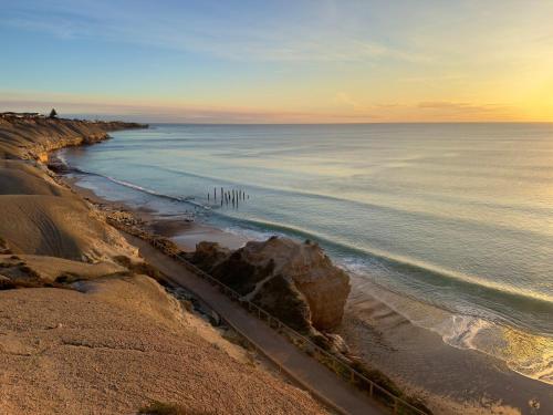 a view of a beach with the ocean at Walk to Beach - Coastal Beach House Retreat in Port Willunga