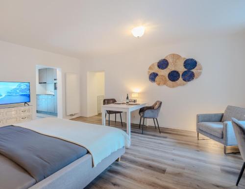 a bedroom with a bed and a table and a couch at Stylish Gem in Kandersteg