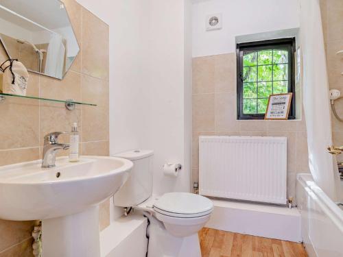 a white bathroom with a sink and a toilet at 2 Bed in Minehead 90925 in Minehead