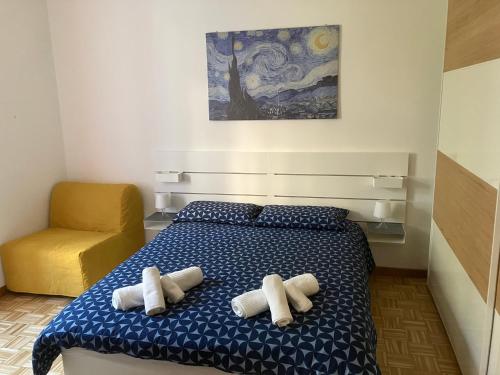a bedroom with a bed with towels on it at Pretty Favetti - lovely apartment in Trieste with a sea view - in Trieste