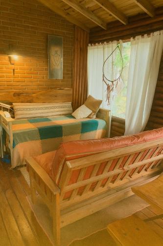 a bedroom with two beds and a window at Cabaña en El Pinar de La lucila del mar -de un piso-, El Pinar -6 personas- in La Lucila del Mar