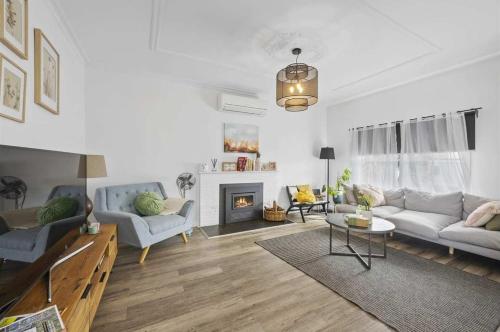 a living room with two couches and a fireplace at Eureka We struck a golden home in Eureka