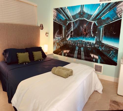 a bedroom with a bed with a painting on the wall at Atrium Design District in Miami