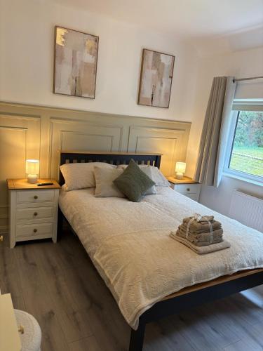 a bedroom with a bed with two night stands and two lamps at Luxury Four Bedroom House in Rock Ferry