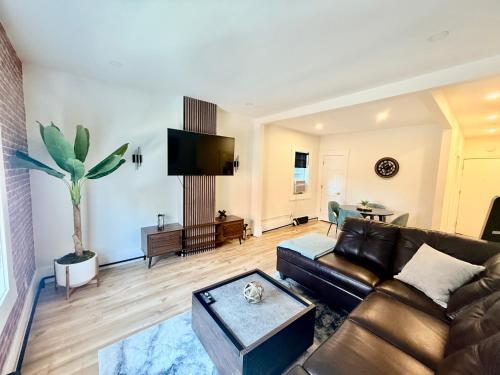 a living room with a couch and a table at Kiari Suites on Main in Moncton
