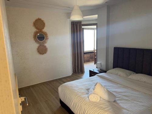 a bedroom with a large bed and a window at Casa de Marinero in Martil