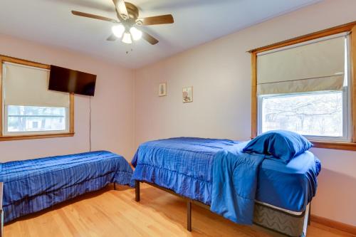 a bedroom with two beds and a ceiling fan at 15 Mi to Cochrans Ski Area Cozy Home with Yard! in Essex Junction