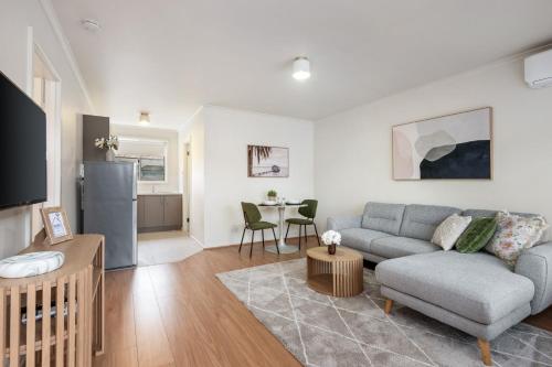 a living room with a couch and a table at Newly Renovated Geelong Serviced Apartments by Short & Long Stays in Geelong