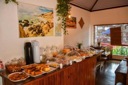 a buffet line with many different types of food at Pousada João Maria in Trancoso