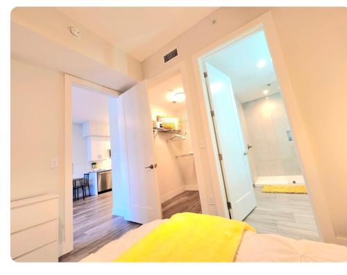 a bedroom with a door leading to a kitchen at Luxe & cozy 3Beds,2rooms,EV Gym Near Beaches&Downtown WPB in West Palm Beach