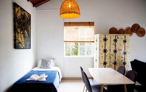 a bedroom with a bed and a table and a window at CASA HOTEL FIBA MAGUEZA in San Francisco