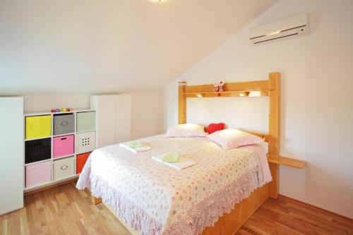 a bedroom with a large bed and a dresser at Apartments with parking space Vrboska, Hvar - 24967 in Vrboska