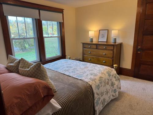 a bedroom with a bed and a dresser and a window at Welcome to Duck Run in Mackeyville, Pennsylvania! in Mill Hall