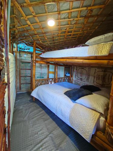 a bedroom with three bunk beds on a boat at Hospedaje casa en el Árbol in Moniquirá