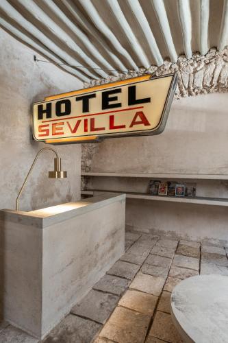 a hotel sign on a wall in a room at Hotel Sevilla, a Member of Design Hotels in Mérida