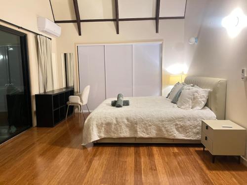 a bedroom with a bed and a large window at Tranquil Hideaway in Mudgeeraba in Gold Coast