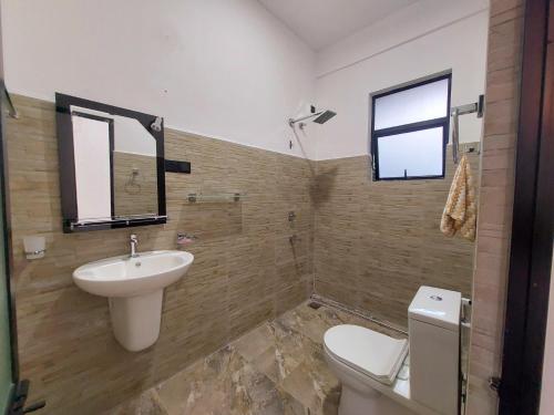 a bathroom with a sink and a toilet at Paboda Residency in Minuwangoda