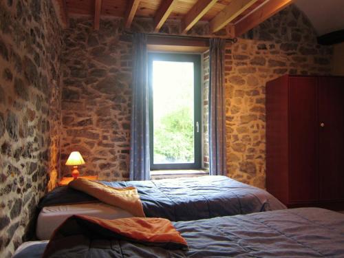 a bedroom with two beds and a window at Alpine Getaway in Neustift in Treignes