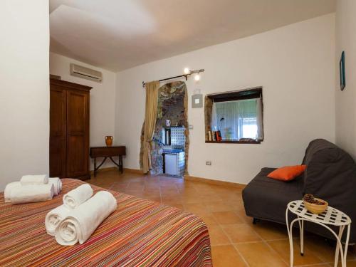 a living room with a bed and a couch at Romantic Stay Near Velia in Marina di Ascea