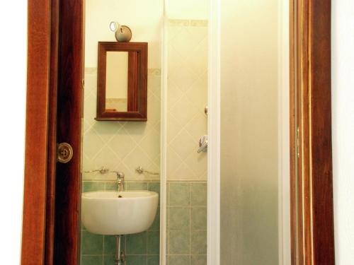 a bathroom with a sink and a mirror at Villa in Velia near Roman Ruins and Beach in Marina di Ascea