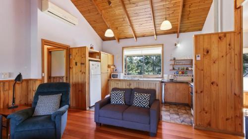 a living room with two chairs and a kitchen at Halcyon - Peaceful Family Retreat in Nungurner