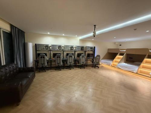 a room with a group of chairs and a dressing room at Hulk Esports Cinema Hotel Guiyang Fountain Pool Branch in Guiyang