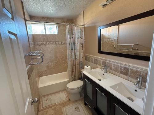 a bathroom with a sink and a toilet and a shower at South OC House in Laguna Niguel