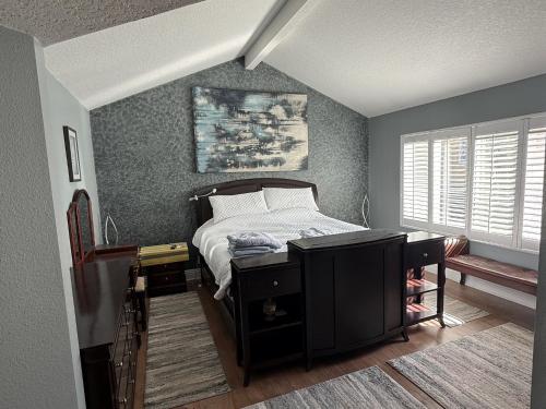 a small bedroom with a bed and a window at South OC House in Laguna Niguel