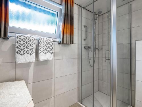 a bathroom with a shower and a window at Ferienwohnung, Oberkirchen in Schmallenberg