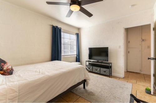a bedroom with a bed and a flat screen tv at *Free Parking near Strip Cozy 2Br home Side: A in Las Vegas
