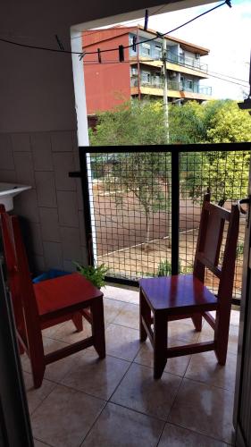 a room with two chairs and a table and a window at San Martin Apart in Puerto Rico