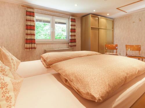 a bedroom with two beds and a table and chairs at Ferienwohnung, Oberkirchen in Schmallenberg