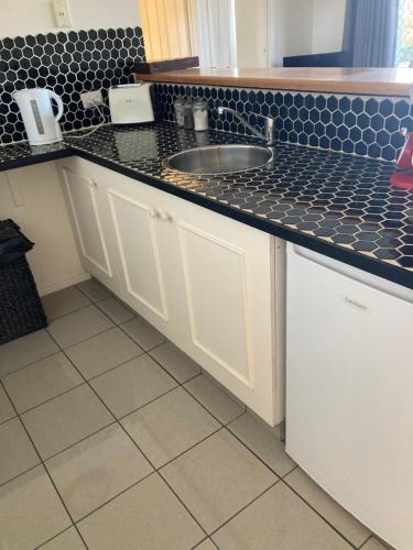 a kitchen with a sink and a counter top at Kingston apartment in Kingston