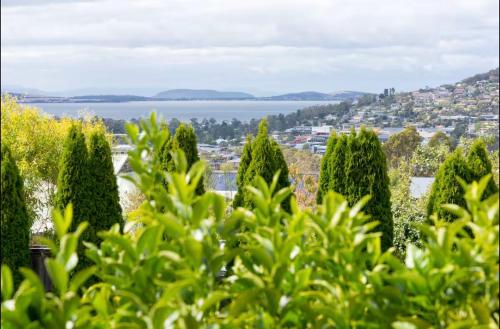 a view of a city from behind some trees at Kingston apartment in Kingston