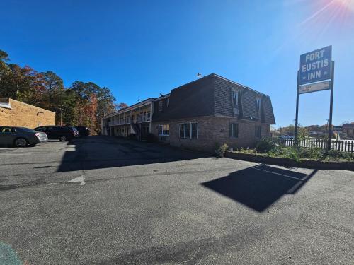 a building with a sign on the side of a street at Fort Eustis INN in Newport News