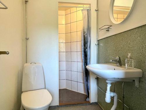 a bathroom with a toilet and a sink at 5 person holiday home in Mörlunda-By Traum in Tulunda