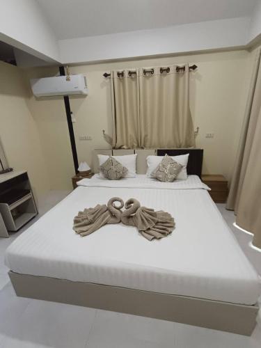 a large bed with two rings on top of it at Lanta summer house nui bay in Ko Bu Bu