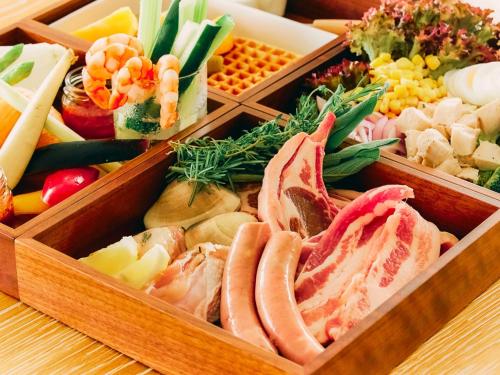 two wooden trays filled with different types of food at Umiyama Chikura in Minamiboso