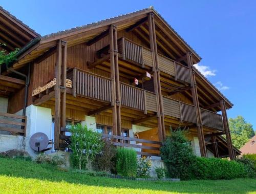 a large wooden house with wooden balconies on it at Stockenmatt Haus 2, Wohnung 22 in Stalden