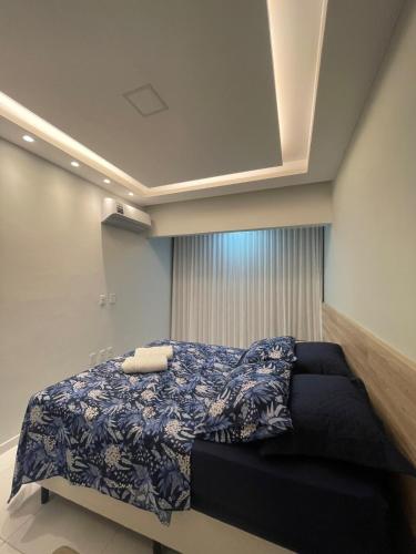 a bedroom with a bed with a blue comforter at Ap 304 Via Mares do Frances in Marechal Deodoro