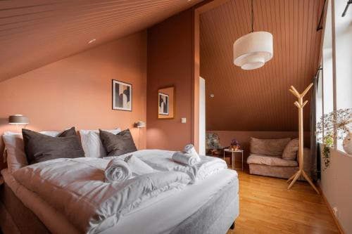 a bedroom with a large bed with towels on it at ARCTIC HOMES - The Spacious Villa in Tromsø