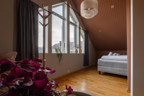 a room with a bed and a large window at ARCTIC HOMES - The Spacious Villa in Tromsø