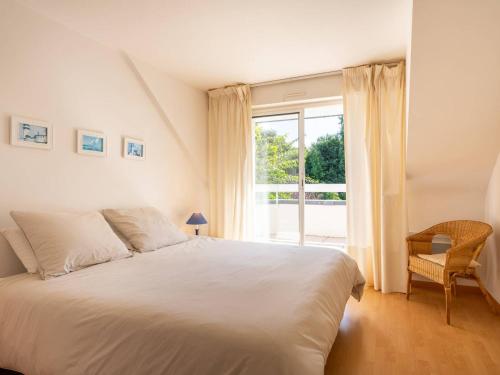 a bedroom with a white bed and a window at Carnac - Maison d'Architecte 7 Pièces 165m² - Wifi - FR-1-477-270 in Carnac