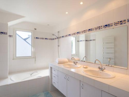 a white bathroom with two sinks and a bath tub at Carnac - Maison d'Architecte 7 Pièces 165m² - Wifi - FR-1-477-270 in Carnac