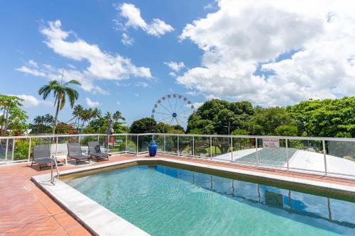 a swimming pool with a ferris wheel in the background at BreakFree Royal Harbour in Cairns